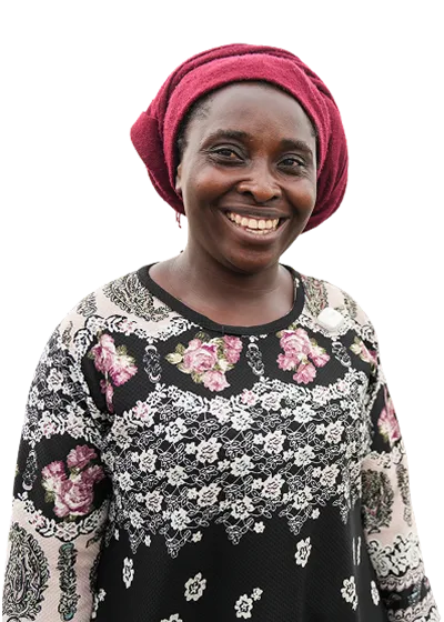 Smiling woman in a maroon headscarf and floral-patterned top.